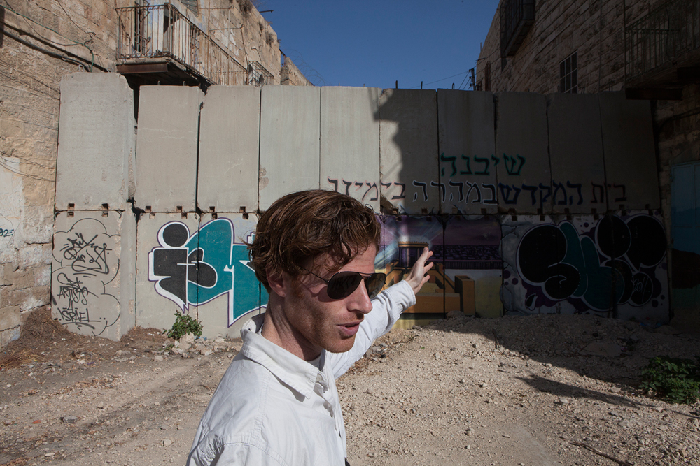 Veteran points to a barrier erected by the IDF 